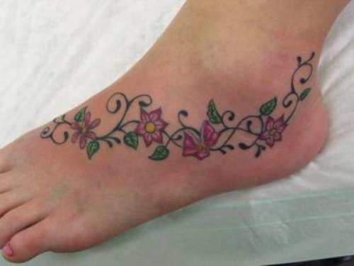 Flowers And Barbed Wire Tattoo On Left Foot